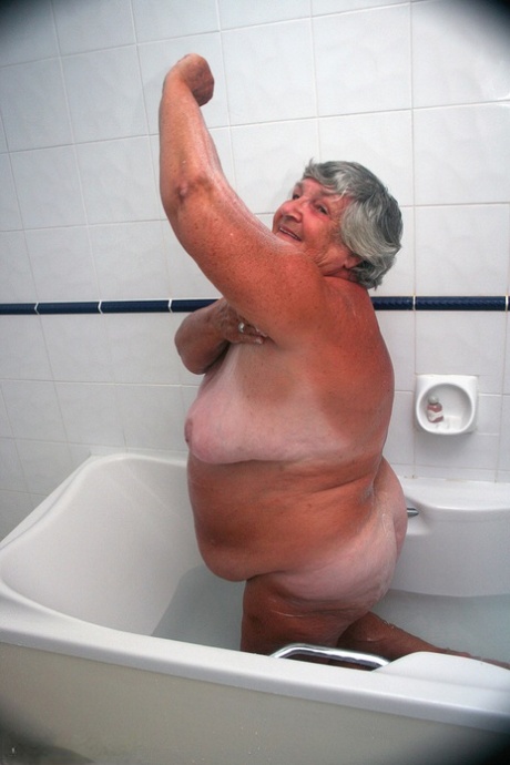 older woman removing clothes hot image